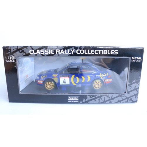 Two 1/18 scale diecast Subaru rally cars as driven by Colin McRae and ...