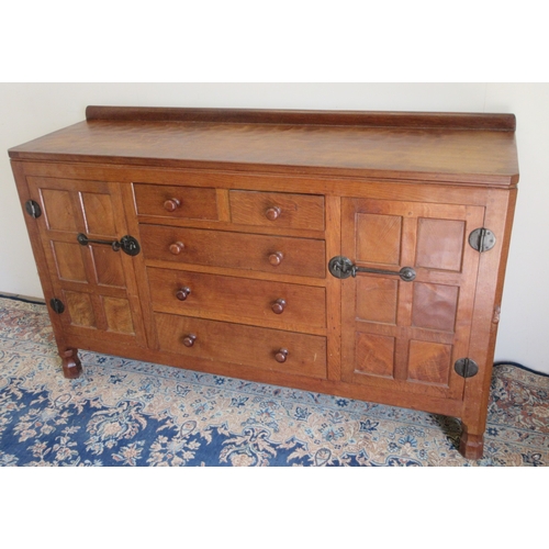 Robert Mouseman Thompson of Kilburn - an oak sideboard, adzed top with upstand above two short and three long drawers with turned wooden handles, enclosed by two six panel doors with iron hinges and latches, six panel sides on octagonal supports, carved with signature mouse, W152cm D47cm H82cm

POA  https://www.bradleys.ltd/quotation-request-form
