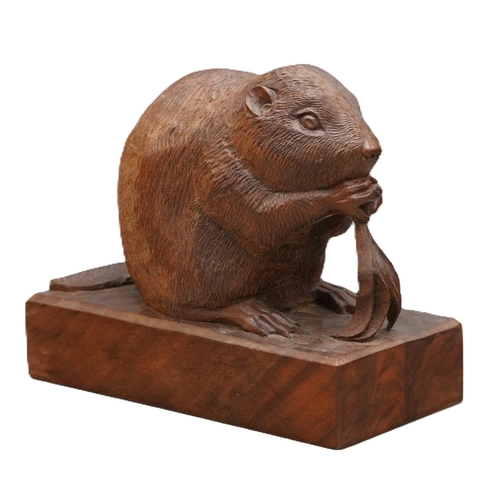 Peter Raymond Stout - carved wood model of a seated Beaver eating leafage, on adzed top rectangular plinth, carved in two halves, W19cm D9cm H16cm

Shipping £38.00 plus vat (UK Only)