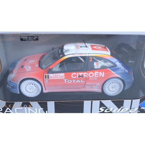 Three weathered 1/18 scale diecast rally car models from Solido