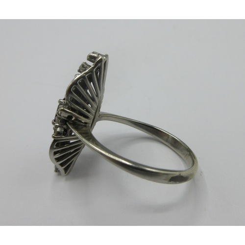 1110 - C1970s white metal three stone cluster ring set with three rubies surrounded by a shaped border set ... 