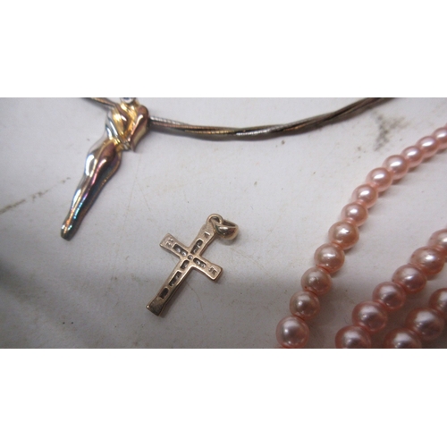 34 - Two 9ct yellow gold cross pendants, one set with diamonds, both stamped 375, 2.25g, a single silver ... 