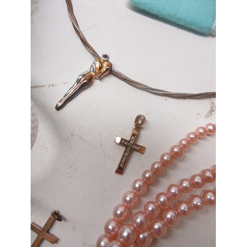 34 - Two 9ct yellow gold cross pendants, one set with diamonds, both stamped 375, 2.25g, a single silver ... 