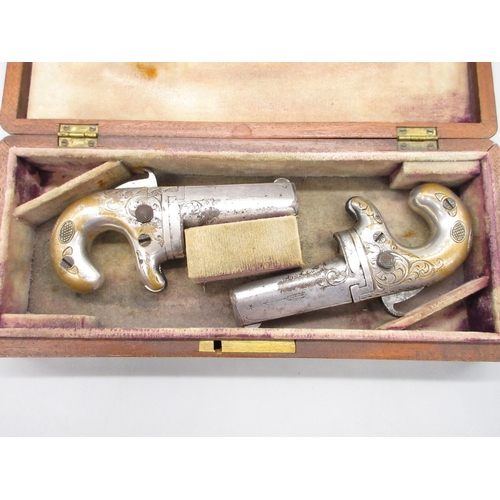 24 - Cased matched pair of Moores Patent .41 rimfire Derringer pistols, nickel plated with scroll engravi... 
