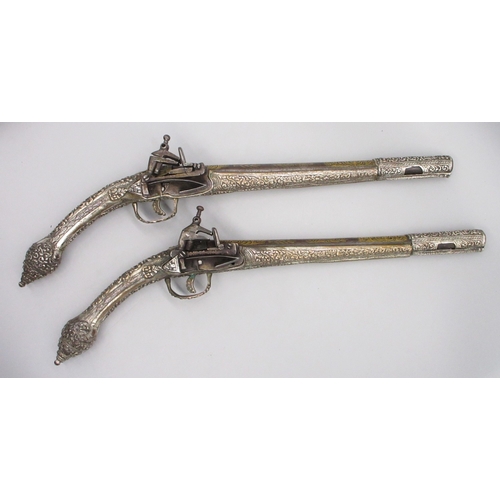 Pair of 22 bore Miquelet Greek/Balkan holster pistols, 12" barrels with gilt inlaid detail, chased muzzle bands, faux ramrods,  49cm overall

Shipping £48.00 plus vat (UK Only)