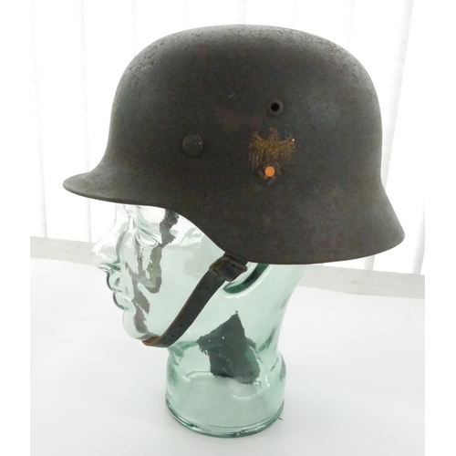 WWII M-35 Single Decal German Army Steel helmet serial number 4860. With Soldiers name and replacement liner and strap

Shipping £38.00 plus vat (UK Only)