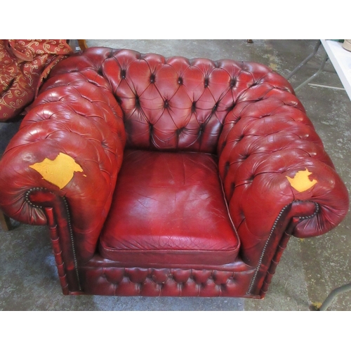 298 - Chesterfield chair, deep buttoned red leather upholstered with loose seat cushion, and red scroll lo... 