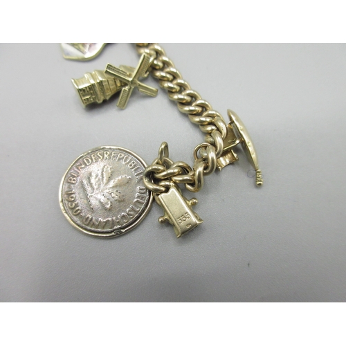 58 - 8ct yellow gold charm bracelet, stamped 333, with a selection of charms stamped at 14ct, 18ct or unm... 