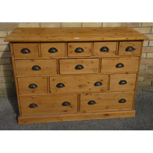 Modern pine bank of twelve drawers, with metal handles on plinth base ...