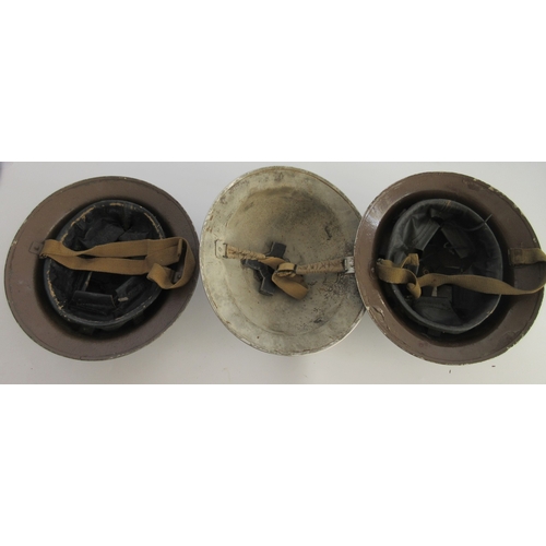 200 - Three WWII British Brodie helmets, two brown painted with full liner and chin strap, grey painted, o... 