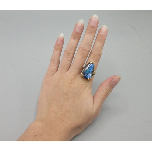 1037 - 9ct yellow gold ring set with natural black opal, stone L25mm, stamped 375, size O, 10.8g

Bradleys ... 