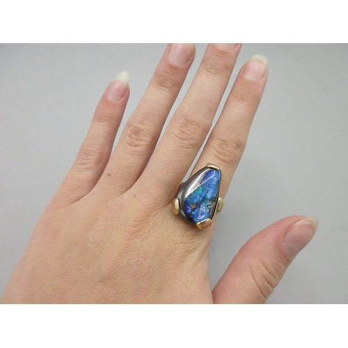 1037 - 9ct yellow gold ring set with natural black opal, stone L25mm, stamped 375, size O, 10.8g

Bradleys ... 