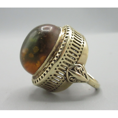 1017 - 9ct yellow gold cocktail ring set with large amber stone, stamped 750, size L, 10.7g

Bradleys shipp... 