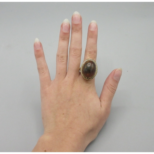 1017 - 9ct yellow gold cocktail ring set with large amber stone, stamped 750, size L, 10.7g

Bradleys shipp... 