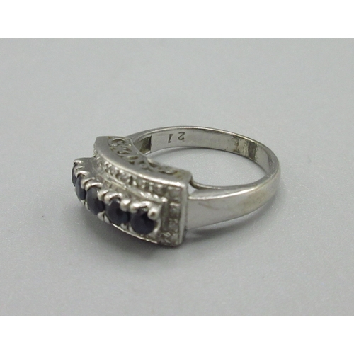 1033 - 18ct white gold ring set with diamonds and a raised row of sapphires, stamped 18k, size M1/2, 4.8g

... 