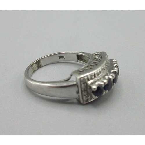 1033 - 18ct white gold ring set with diamonds and a raised row of sapphires, stamped 18k, size M1/2, 4.8g

... 