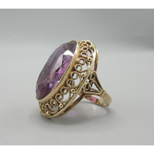 1025 - Polish 14ct rose gold cocktail ring set with large amethyst stone with ornate rim, stamped 3, town o... 