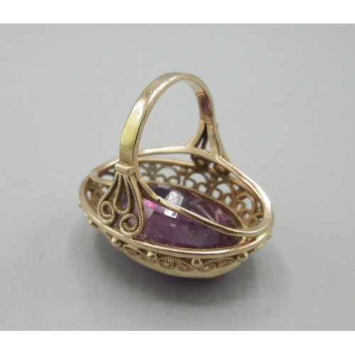 1025 - Polish 14ct rose gold cocktail ring set with large amethyst stone with ornate rim, stamped 3, town o... 