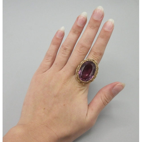 1025 - Polish 14ct rose gold cocktail ring set with large amethyst stone with ornate rim, stamped 3, town o... 