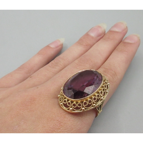1025 - Polish 14ct rose gold cocktail ring set with large amethyst stone with ornate rim, stamped 3, town o... 