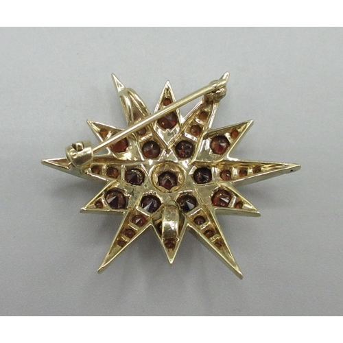 1045 - Victorian style 9ct yellow gold starburst brooch set with garnets, stamped 375, L4cm, 7.8g

Bradleys... 