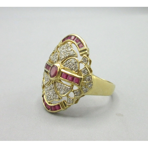 1009 - Art Deco style 18ct yellow gold dress ring adorned with rubies and diamonds, stamped 750, face L25mm... 