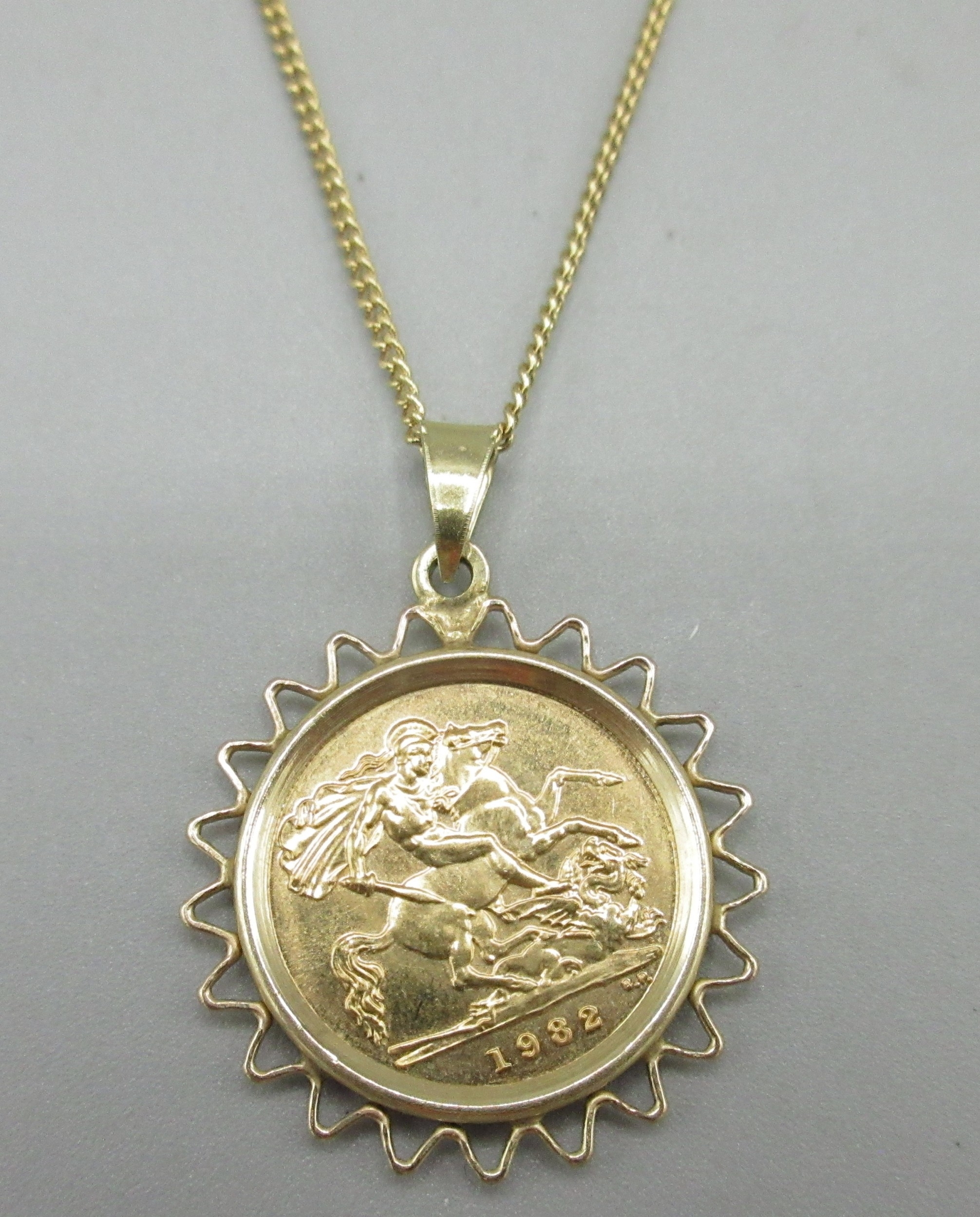 ER.II 1982 half sovereign in 9ct yellow gold sovereign mount on an ...