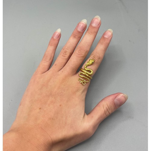 1020 - 18ct yellow gold snake ring set with sapphire eyes, stamped 750, size K, 7.6g

Bradleys shipping £23... 