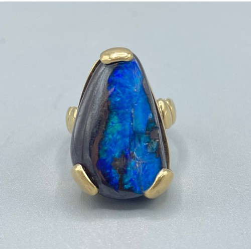 1037 - 9ct yellow gold ring set with natural black opal, stone L25mm, stamped 375, size O, 10.8g

Bradleys ... 