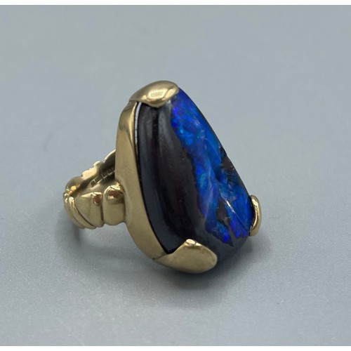 1037 - 9ct yellow gold ring set with natural black opal, stone L25mm, stamped 375, size O, 10.8g

Bradleys ... 