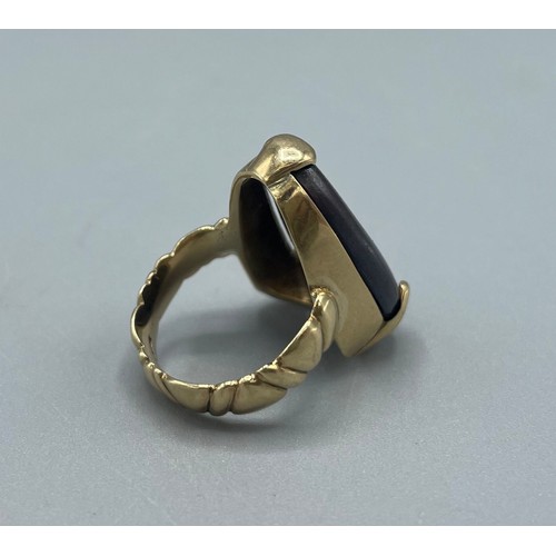 1037 - 9ct yellow gold ring set with natural black opal, stone L25mm, stamped 375, size O, 10.8g

Bradleys ... 