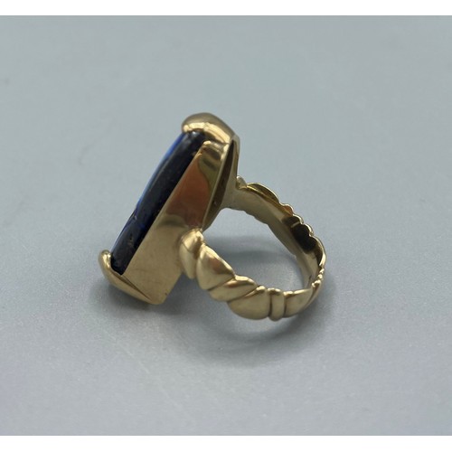 1037 - 9ct yellow gold ring set with natural black opal, stone L25mm, stamped 375, size O, 10.8g

Bradleys ... 