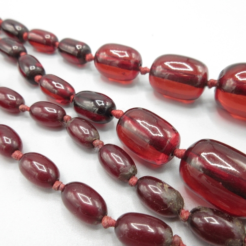 1039 - Cherry amber graduated bead necklace, strung knotted, approximate L110, largest bead 25mm

Bradleys ... 