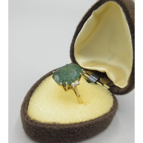 1013 - 20th century 18ct yellow gold ring set with large cushion cut emerald flanked by two diamonds, emera... 