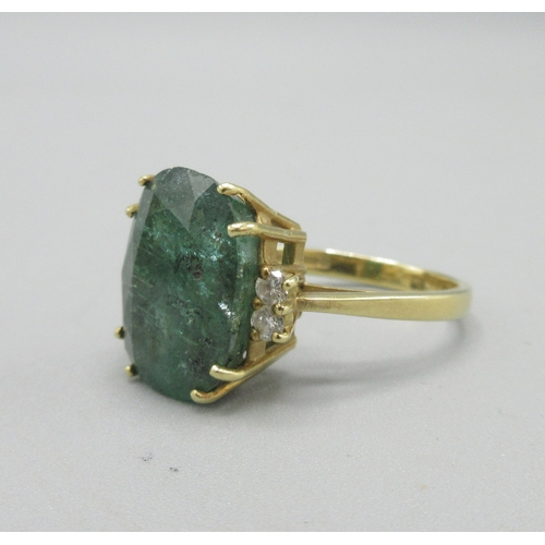 1013 - 20th century 18ct yellow gold ring set with large cushion cut emerald flanked by two diamonds, emera... 