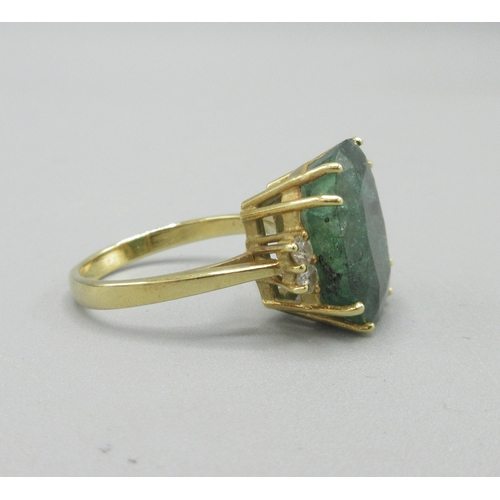 1013 - 20th century 18ct yellow gold ring set with large cushion cut emerald flanked by two diamonds, emera... 