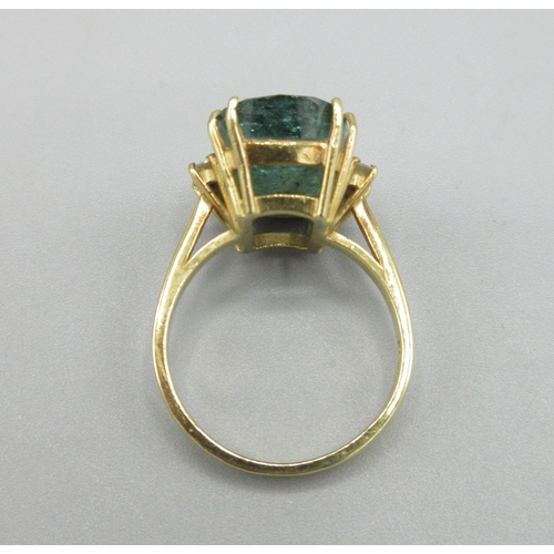 1013 - 20th century 18ct yellow gold ring set with large cushion cut emerald flanked by two diamonds, emera... 
