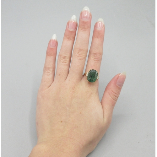 1013 - 20th century 18ct yellow gold ring set with large cushion cut emerald flanked by two diamonds, emera... 