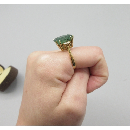 1013 - 20th century 18ct yellow gold ring set with large cushion cut emerald flanked by two diamonds, emera... 