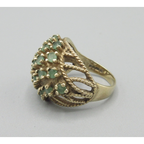 1044 - 9ct yellow gold cocktail cluster ring set with emerald, stamped 375, size N, 7.6g

Bradleys shipping... 