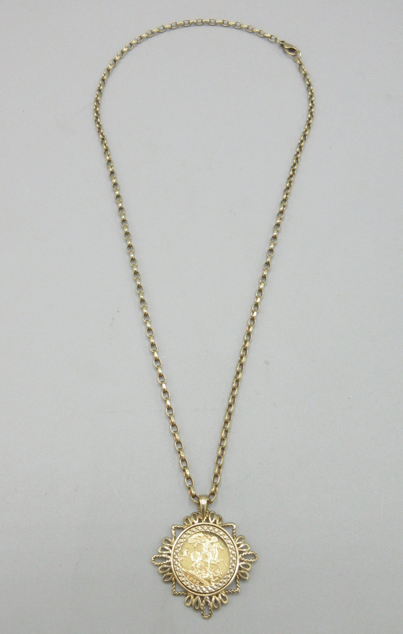 Elizabeth II 1992 half sovereign in 9ct yellow gold pendant mount on a ...