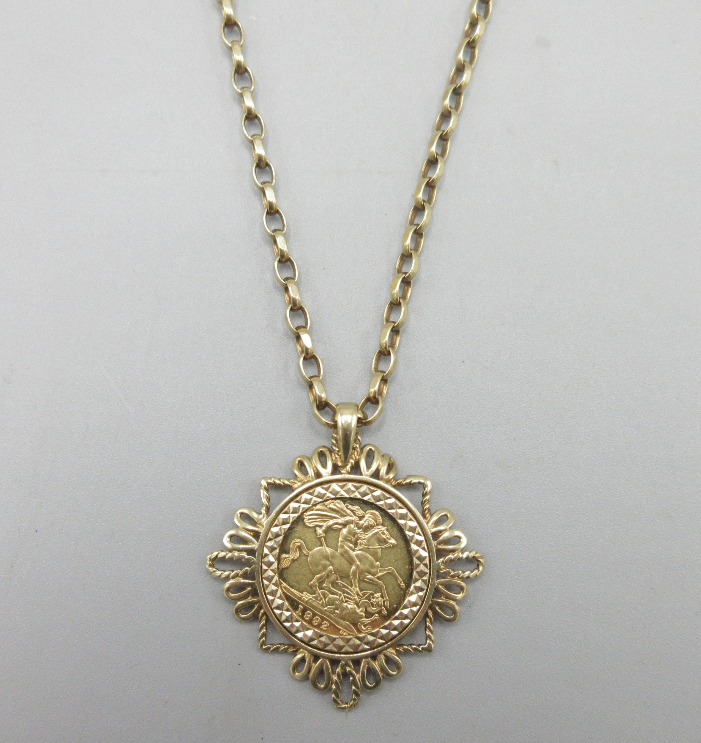 Elizabeth II 1992 half sovereign in 9ct yellow gold pendant mount on a ...