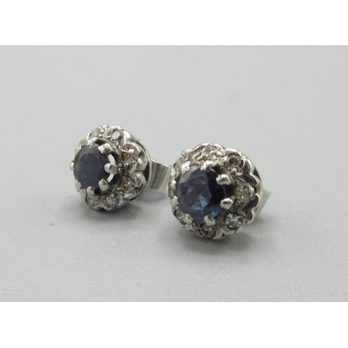1055 - Pair of unmarked white metal stud earrings set with sapphire and a halo of diamonds, 2.5g

Bradleys ... 