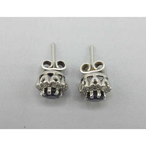 1055 - Pair of unmarked white metal stud earrings set with sapphire and a halo of diamonds, 2.5g

Bradleys ... 