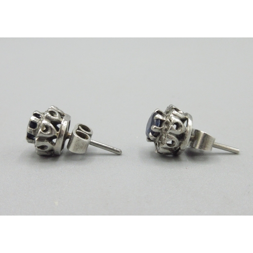 1055 - Pair of unmarked white metal stud earrings set with sapphire and a halo of diamonds, 2.5g

Bradleys ... 