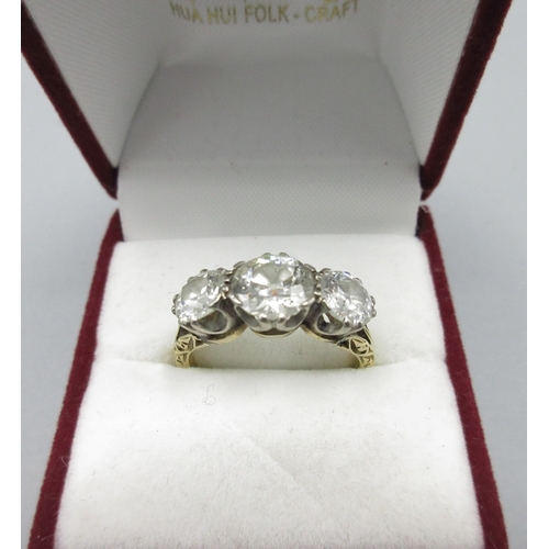1002 - 18ct yellow gold trilogy ring, three round brilliant cut diamonds in claw setting, central diamond a... 