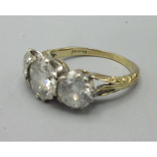 1002 - 18ct yellow gold trilogy ring, three round brilliant cut diamonds in claw setting, central diamond a... 