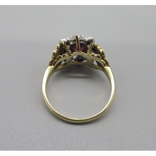 1034 - Georgian style 18ct yellow gold ruby and diamond ring, oval cut ruby with a pierced halo of diamonds... 