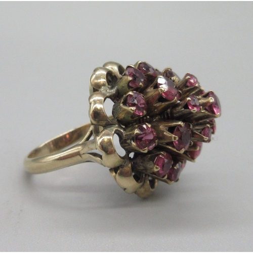 1031 - 18ct yellow gold princess ring set with twenty-one rubies, stamped 18k, size K, 6.6g

Bradleys shipp... 