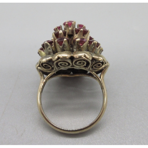 1031 - 18ct yellow gold princess ring set with twenty-one rubies, stamped 18k, size K, 6.6g

Bradleys shipp... 